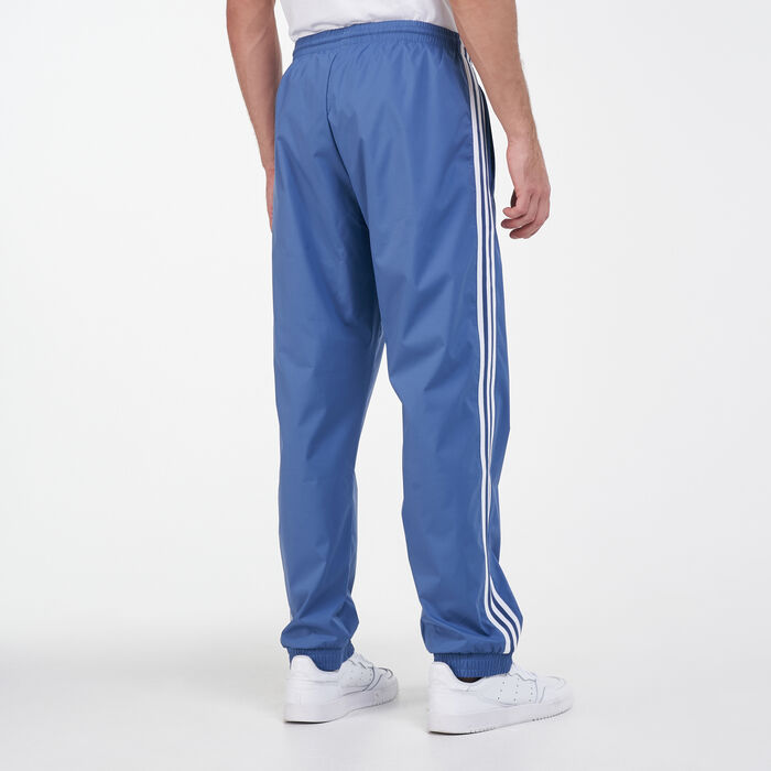 adidas Originals adicolor three stripe track pants in blue